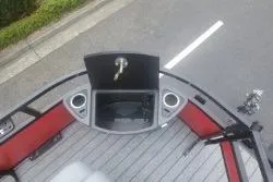 Slide: The Image of 2026 Ranger 220F boat interior with steering console and seating on a road. - 46