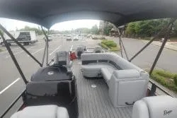 Slide: The Image of 2026 Ranger 220F pontoon boat on trailer, featuring spacious seating and canopy. - 8