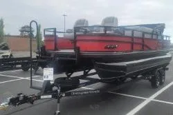 The Image of 2026 Ranger 220F pontoon boat on trailer in parking lot. - 0