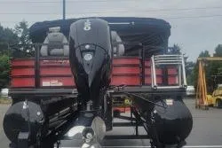 Slide: The Image of 2026 Ranger 220F pontoon boat with outboard motor, parked outdoors. - 4