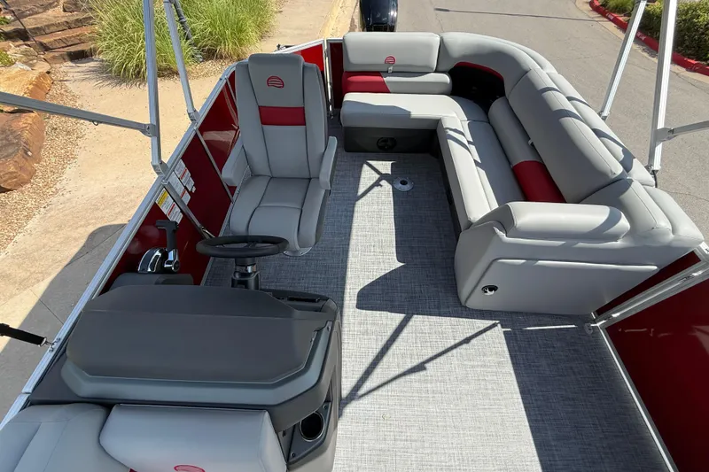 Slide: The Image of 2026 Sun Tracker Party Barge 20 DLX interior with gray seating and red accents. - 5