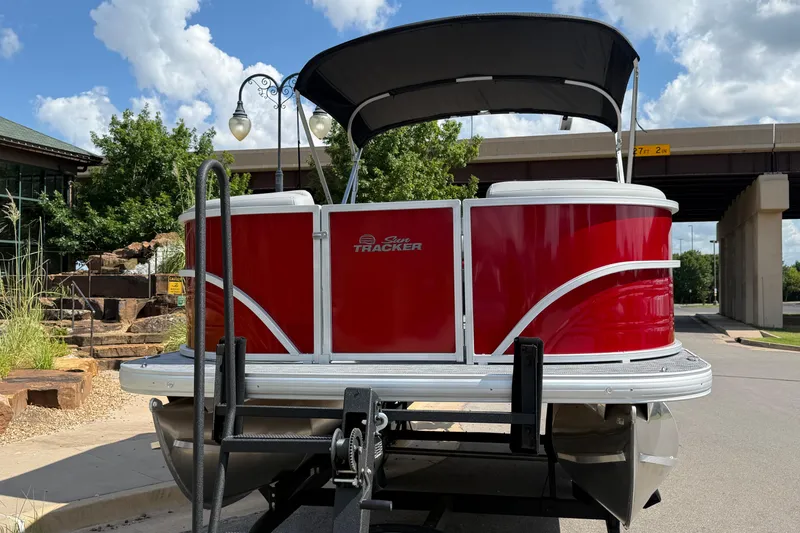 Slide: The Image of 2026 Sun Tracker Party Barge 20 DLX pontoon boat with red exterior and canopy. - 2