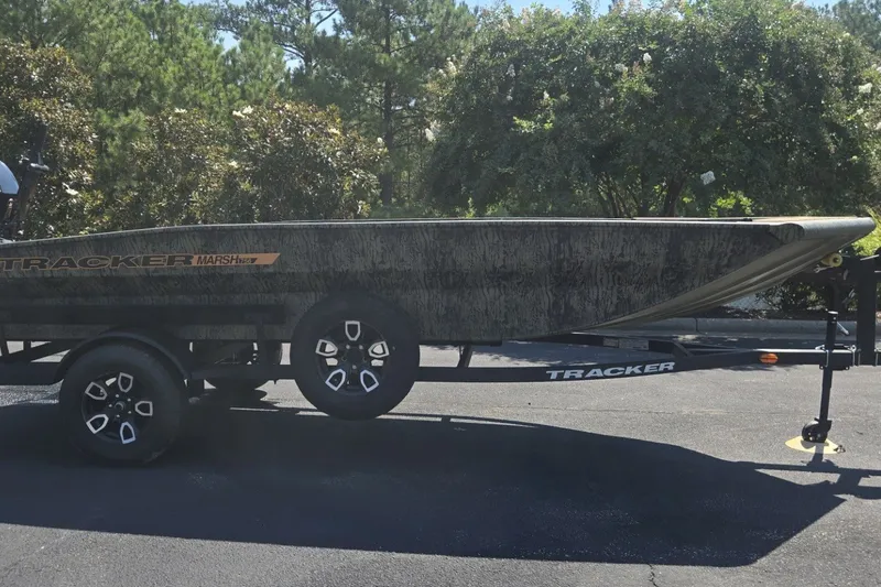 The Image of 2026 Tracker Grizzly 1756 T Marsh boat on trailer, parked outdoors. - 0