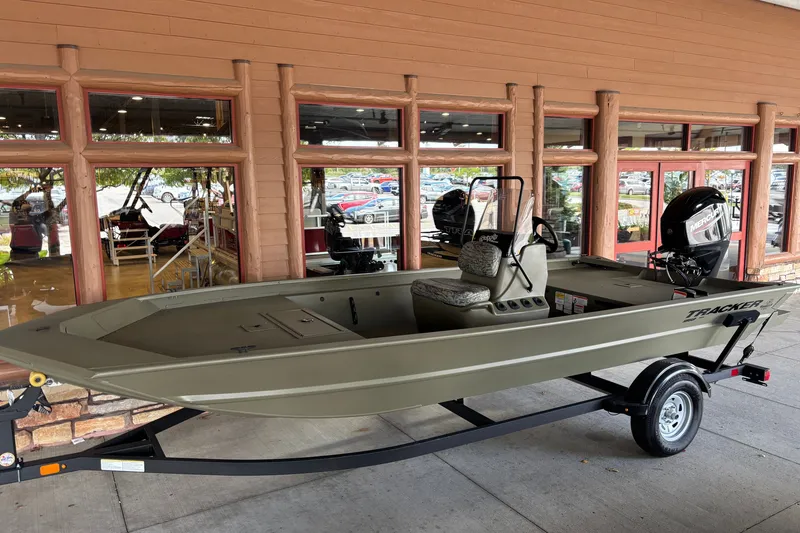 The Image of 2026 Tracker Grizzly 1860 CC boat on trailer outside a store. - 0
