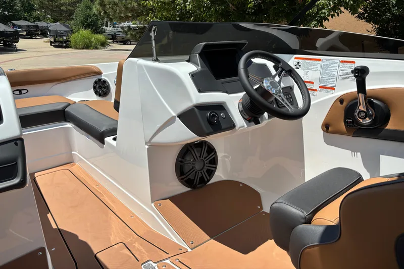 Slide: The Image of 2026 Tahoe 210 S boat interior with modern steering and seating design. - 10