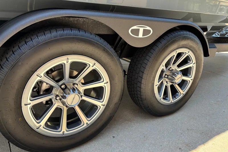 Slide: The Image of 2026 Tahoe 210 S trailer wheels with stylish alloy rims on concrete surface. - 12