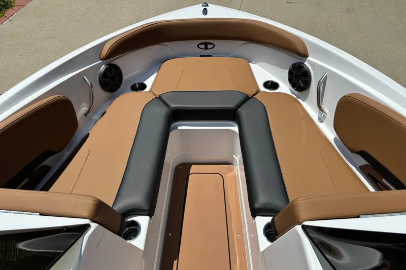 Slide: The Image of 2026 Tahoe 210 S boat interior with tan and black seating, featuring cup holders and speakers. - 4