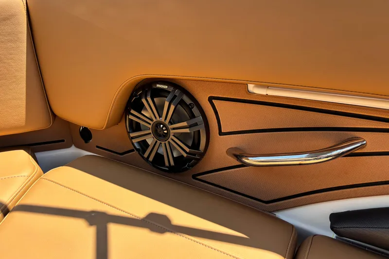 Slide: The Image of 2026 Tahoe 210 S interior with premium speaker and tan leather seating. - 9