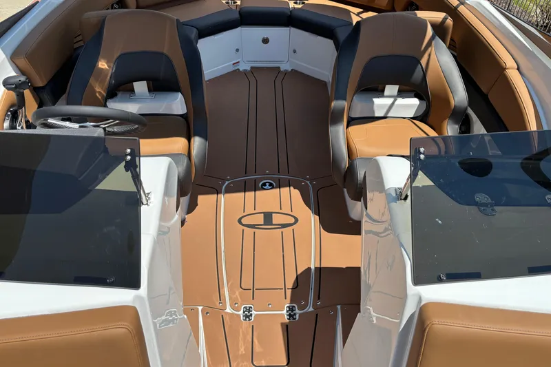 Slide: The Image of 2026 Tahoe 210 S boat interior with brown and black seating, sleek design. - 5