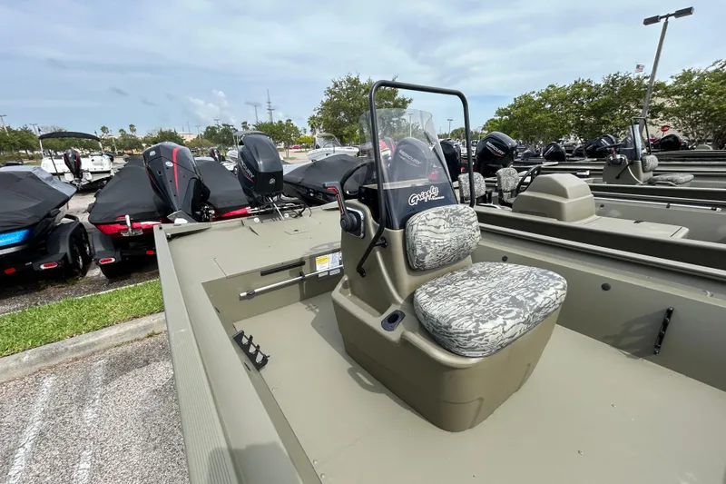 Slide: The Image of 2026 Tracker Grizzly 1860 CC boat with camouflage seats and Mercury outboard motor. - 4