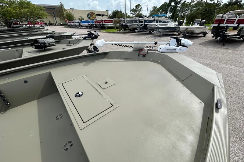 Slide: The Image of 2026 Tracker Grizzly 1860 CC boat with Minn Kota trolling motor in a dealership lot. - 5