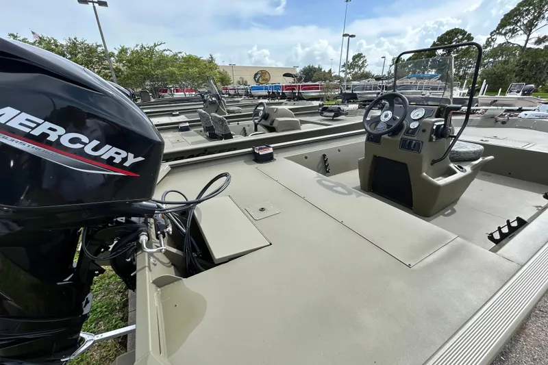 Slide: The Image of 2026 Tracker Grizzly 1860 CC boat with Mercury engine, featuring spacious deck and control console. - 3