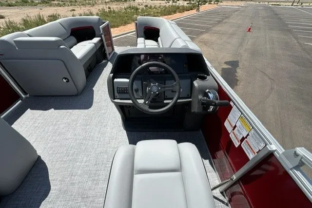 Slide: The Image of 2026 Sun Tracker Party Barge 20 DLX interior with steering wheel and seating. - 17