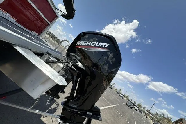 Slide: The Image of 2026 Sun Tracker Party Barge 20 DLX with Mercury outboard motor under a clear blue sky. - 93