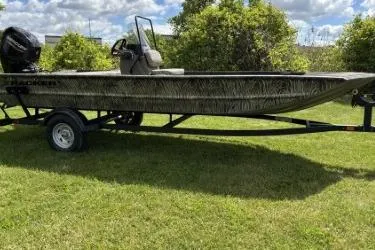 The Image of 2026 Tracker Grizzly 1860 CC boat on trailer, parked on grass. - 0