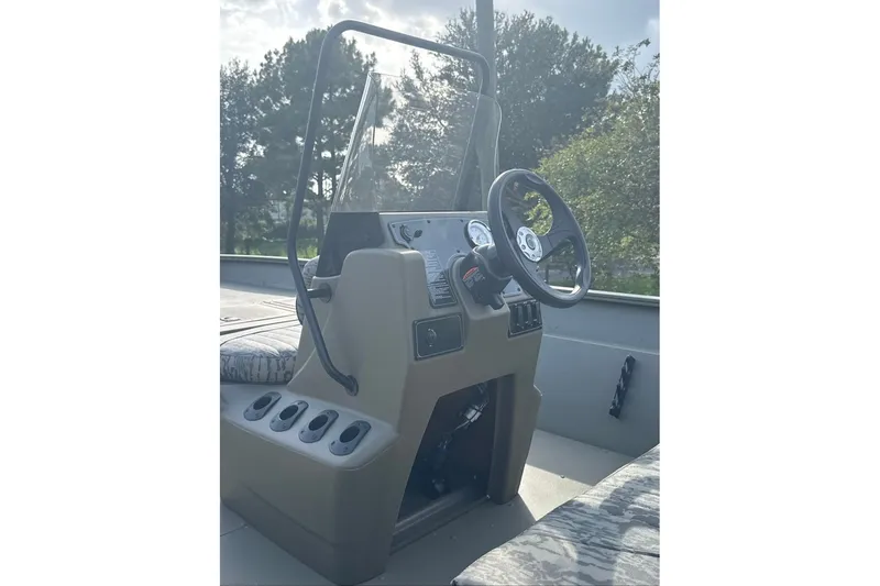 Slide: The Image of 2026 Tracker Grizzly 2072 CC boat console with steering wheel and controls. - 7