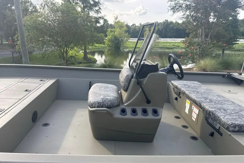 Slide: The Image of 2026 Tracker Grizzly 2072 CC boat interior with seating and steering console. - 5