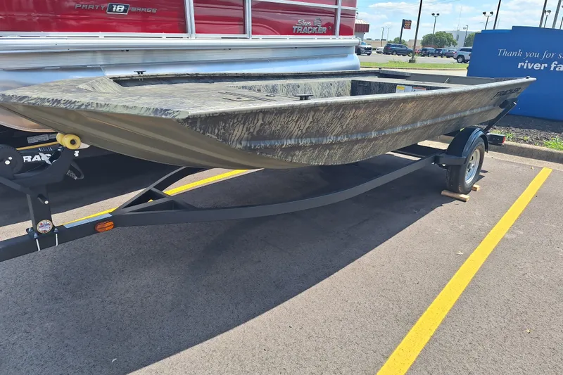 The Image of 2026 Tracker Grizzly 1754 Utility boat on trailer in parking lot. - 0