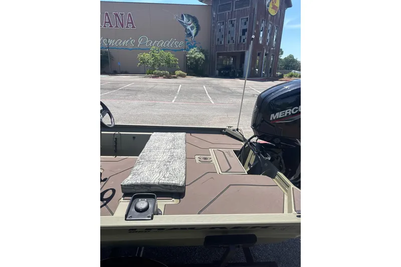 Slide: The Image of 2026 Tracker Grizzly 1860 CC boat with Mercury engine in parking lot. - 6