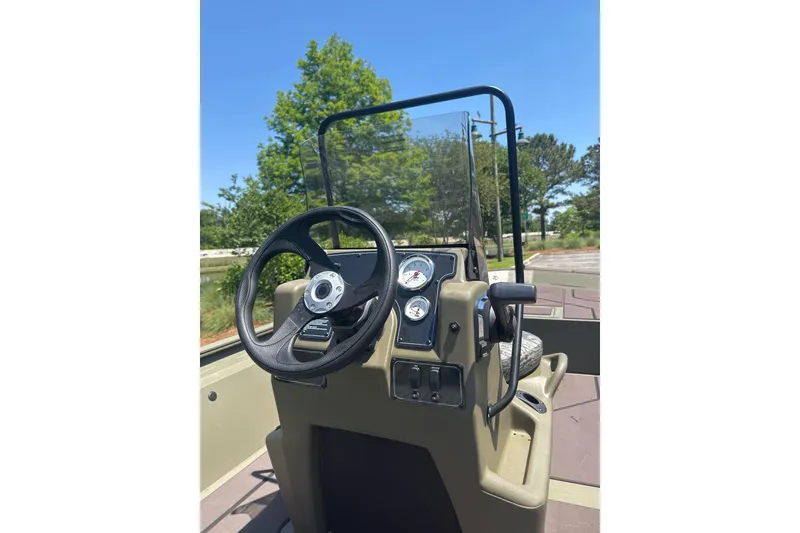 Slide: The Image of 2026 Tracker Grizzly 1860 CC boat console with steering wheel and gauges. - 7