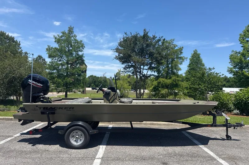 The Image of 2026 Tracker Grizzly 1860 CC boat on trailer in sunny parking lot. - 0
