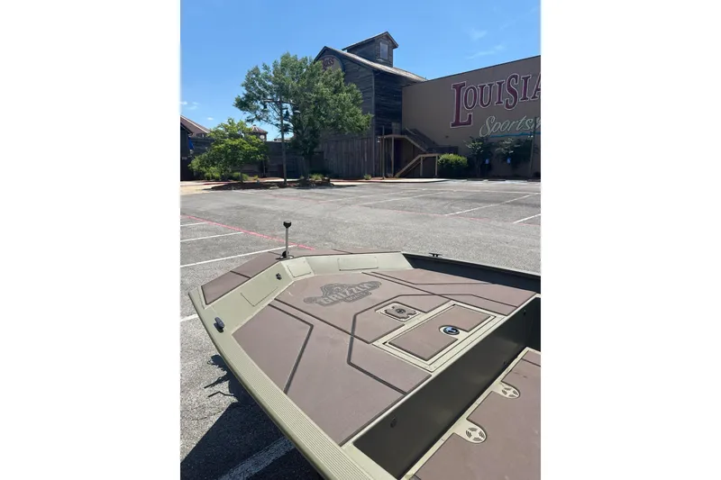 Slide: The Image of 2026 Tracker Grizzly 1860 CC boat in parking lot near Louisiana Sportsman building. - 4