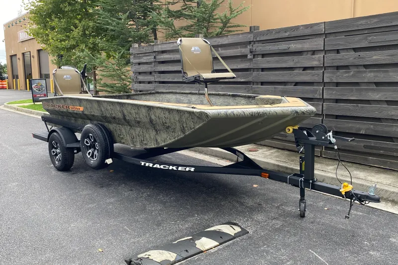 Slide: The Image of 2026 Tracker Grizzly 1756 T Marsh boat on trailer, parked outdoors. - 2
