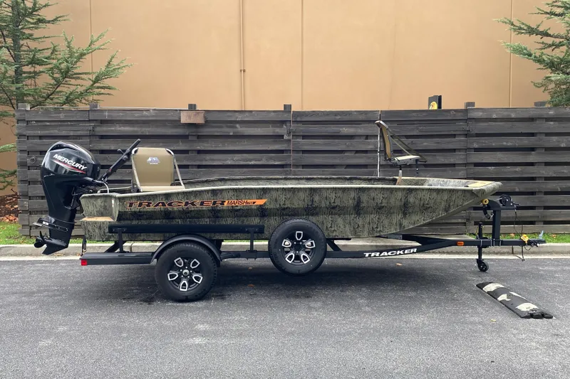 The Image of 2026 Tracker Grizzly 1756 T Marsh boat on trailer, parked outdoors. - 0