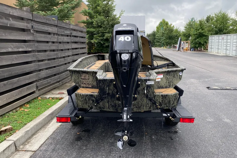 Slide: The Image of 2026 Tracker Grizzly 1756 T Marsh boat with Mercury 40 engine, parked outdoors. - 3