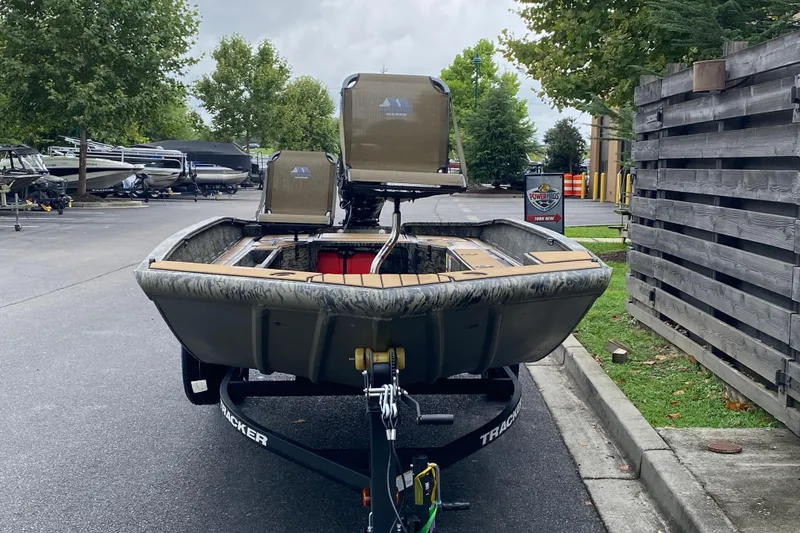 Slide: The Image of 2026 Tracker Grizzly 1756 T Marsh boat on trailer, parked outdoors near other boats. - 4