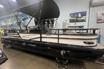 Slide: The Image of 2026 Ranger 220F pontoon boat with canopy in showroom setting. - 2