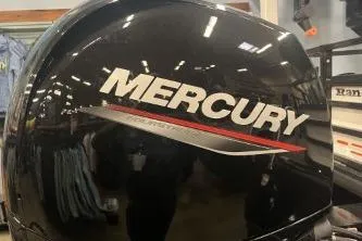 Slide: The Image of Mercury engine on 2026 Ranger 220F boat in showroom setting. - 4