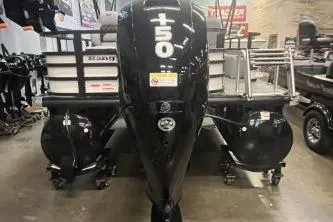 Slide: The Image of 2026 Ranger 220F boat with a 150 horsepower engine displayed indoors. - 1