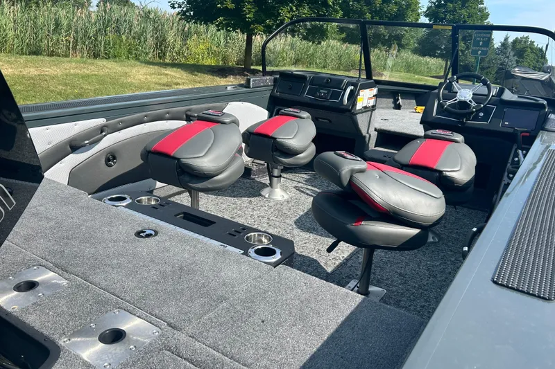 Slide: The Image of 2026 Ranger VX1988 WT boat interior with red and gray seating, steering console, and cup holders. - 4
