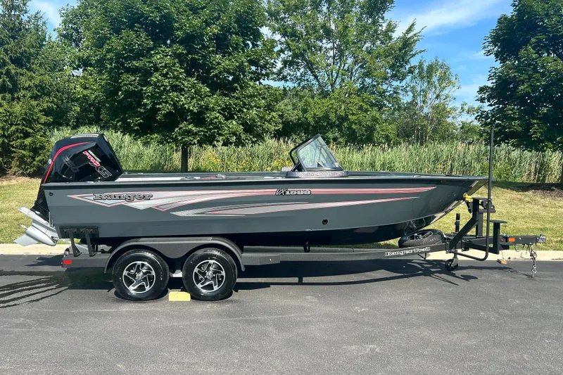Slide: The Image of 2026 Ranger VX1988 WT boat on trailer, parked outdoors with trees in background. - 1