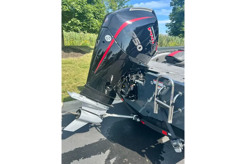 Slide: The Image of Outboard motor on 2026 Ranger VX1988 WT boat, parked on a sunny day. - 3