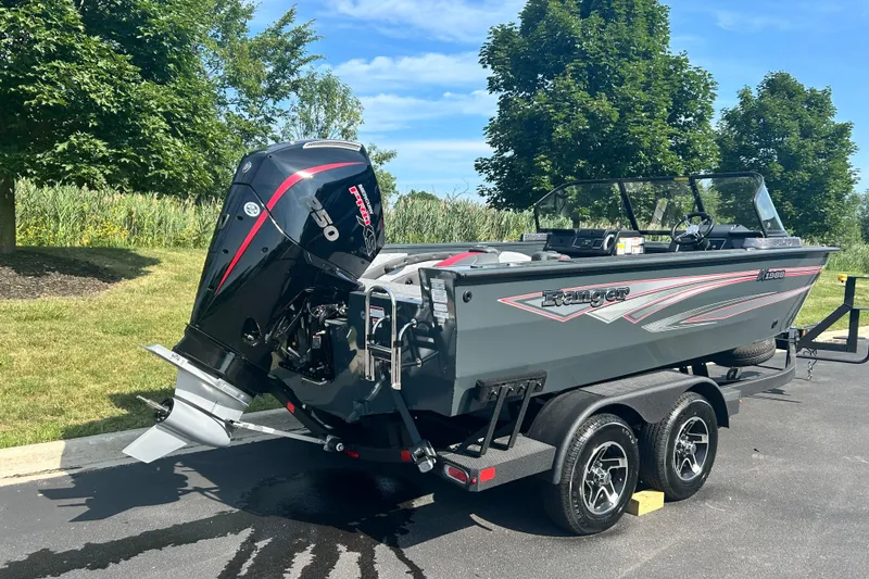 Slide: The Image of 2026 Ranger VX1988 WT boat on trailer, featuring powerful outboard motor, parked outdoors. - 2
