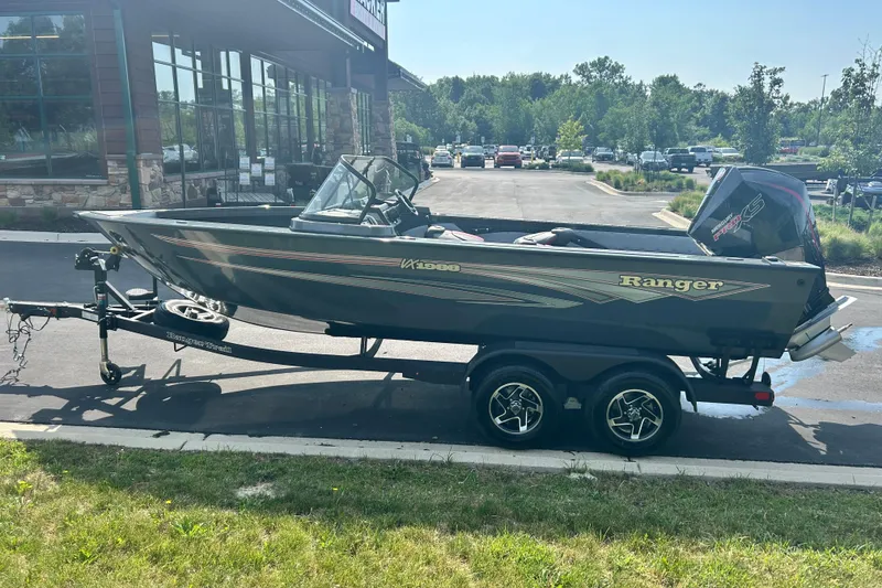 Slide: The Image of 2026 Ranger VX1988 WT boat on trailer, parked outside a building. - 9