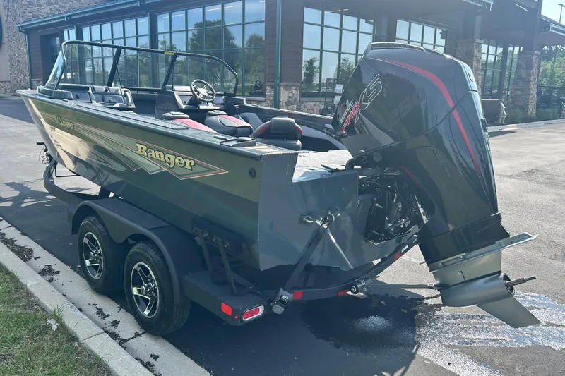 Slide: The Image of 2026 Ranger VX1988 WT boat with powerful outboard motor, parked on a trailer near a building. - 10
