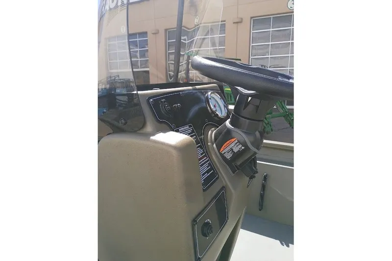 Slide: The Image of Steering console of 2026 Tracker Grizzly 1860 CC boat, featuring gauges and controls. - 54