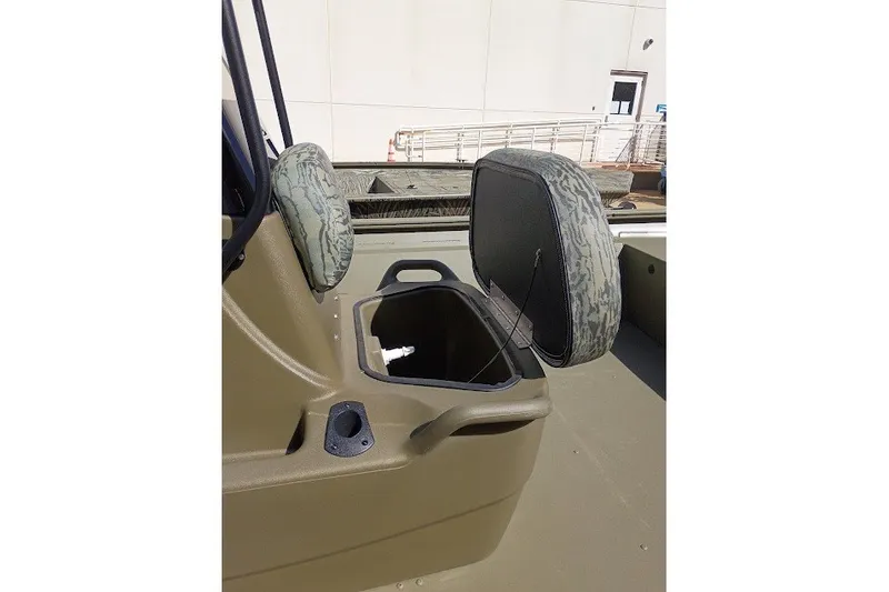 The Image of 2026 Tracker Grizzly 1860 CC boat with open storage compartment and camo seats. - 0