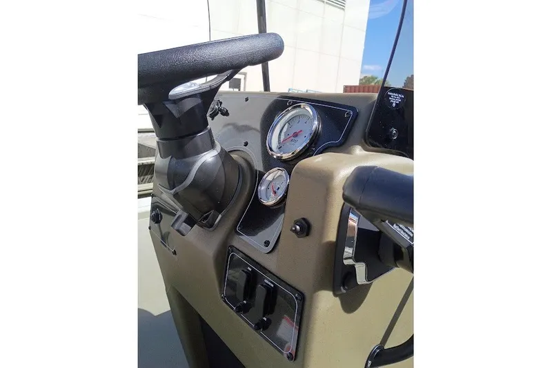 Slide: The Image of Steering console of 2026 Tracker Grizzly 1860 CC boat with gauges and controls. - 20