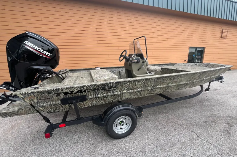 The Image of 2026 Tracker Grizzly 1860 CC boat with Mercury engine on trailer, parked outdoors. - 0