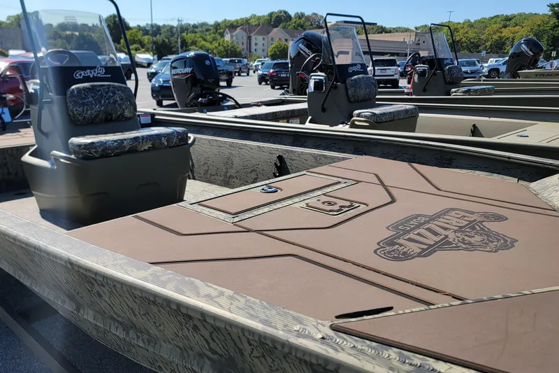 Slide: The Image of 2026 Tracker Grizzly 1860 CC boat with camo seats and Mercury outboard motor. - 3