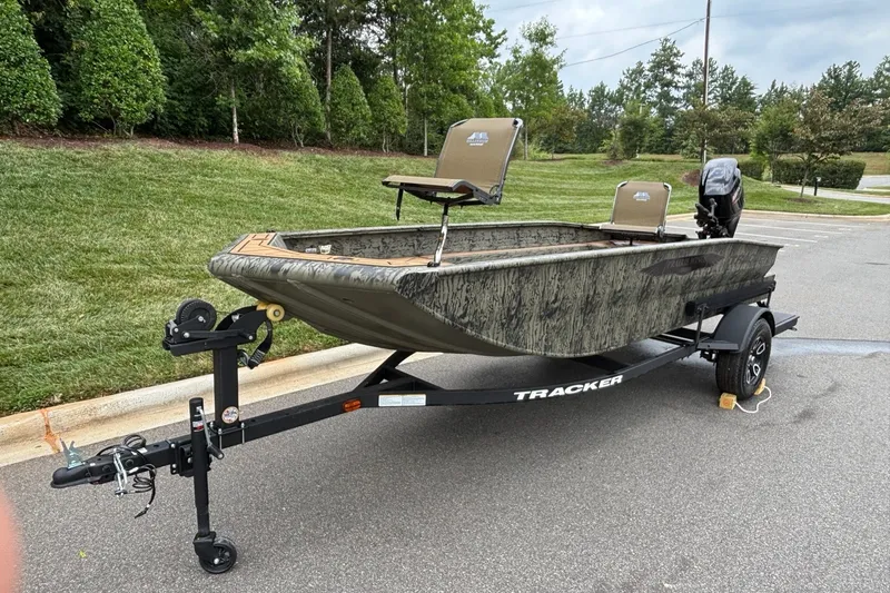 Slide: The Image of 2026 Tracker Grizzly 1650 T Prairie Wings Edition boat on trailer in parking lot. - 2