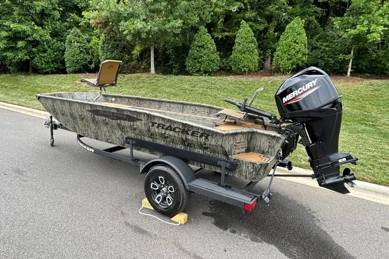 Slide: The Image of 2026 Tracker Grizzly 1650 T Prairie Wings Edition boat with Mercury engine on trailer. - 5
