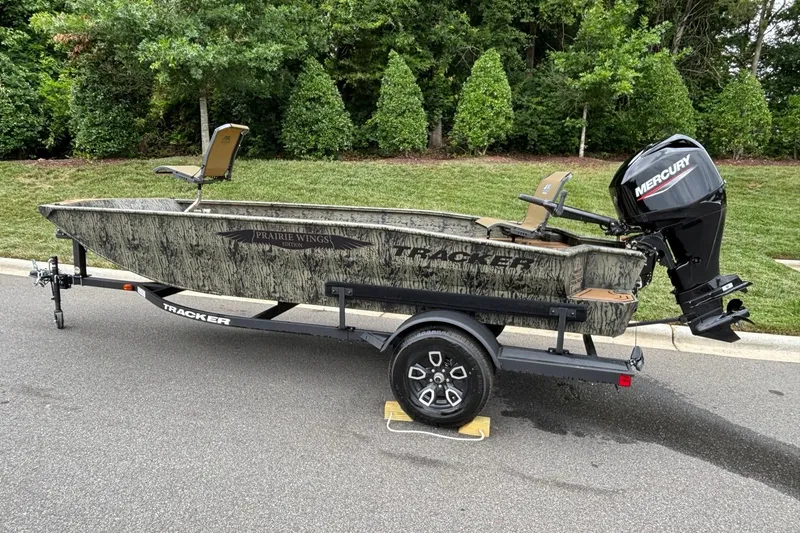 Slide: The Image of 2026 Tracker Grizzly 1650 T Prairie Wings Edition boat on trailer, parked on road. - 4
