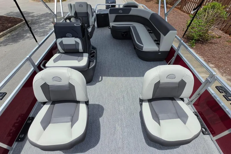 Slide: The Image of 2026 Sun Tracker Bass Buggy 18 DLX pontoon boat interior with gray seating and spacious layout. - 15