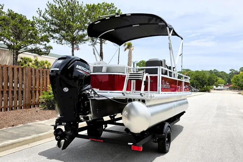 Slide: The Image of 2026 Sun Tracker Bass Buggy 18 DLX pontoon boat with Mercury outboard motor on trailer. - 4