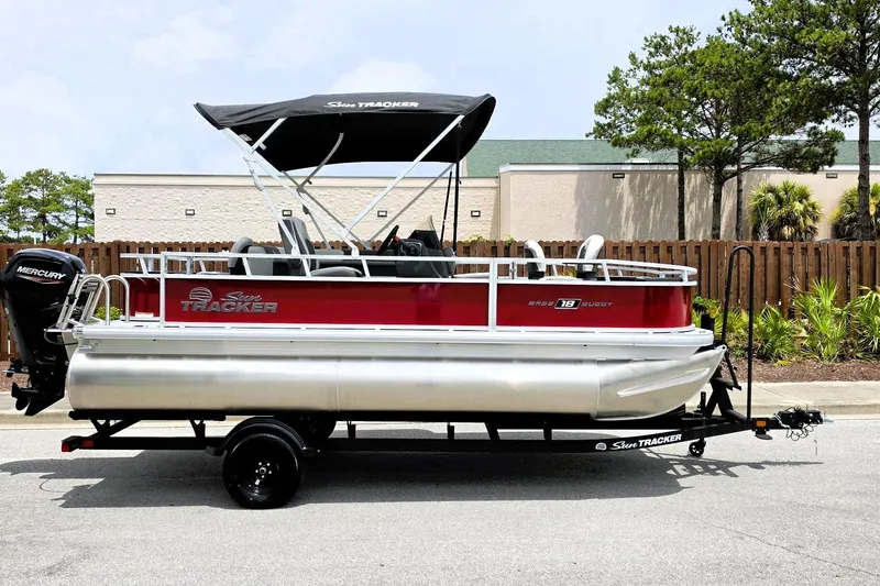 The Image of 2026 Sun Tracker Bass Buggy 18 DLX pontoon boat with Mercury engine on trailer. - 0